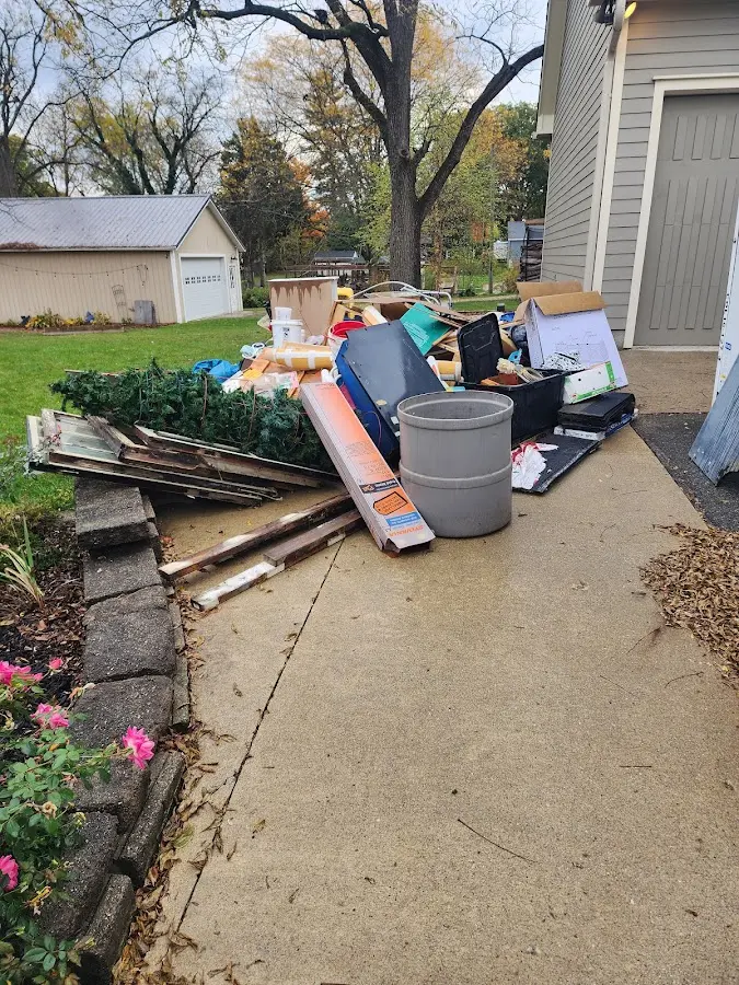 Dumpster being loaded with debris for Roofing Dumpster Rental in Corydon